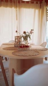 a table with a vase of flowers on top of it at Koochill in Koczała