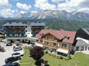 an aerial view of a hotel with mountains in the background at Hotel Moser in Schladming