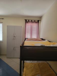 a bedroom with a bed and a window and two closets at Hostel Dubrovnik Center Free Parking in Dubrovnik