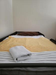 a bed with two towels sitting on top of it at Hostel Dubrovnik Center Free Parking in Dubrovnik