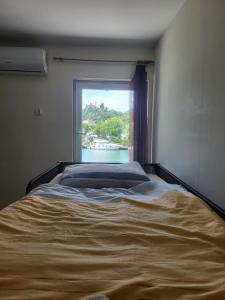 a bedroom with a large bed with a window at Hostel Dubrovnik Center Free Parking in Dubrovnik