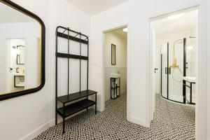a hallway with a mirror and a black shelf at APLEND CITY Paul Inn in Bratislava