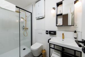 a bathroom with a toilet and a sink and a shower at APLEND CITY Paul Inn in Bratislava