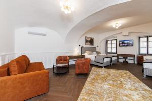 a living room with a bed and a couch and chairs at APLEND CITY Paul Inn in Bratislava +34 photos