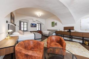 a room with two beds and a table and chairs at APLEND CITY Paul Inn in Bratislava