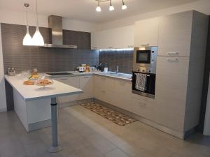 a kitchen with a sink and a stove top oven at Bed & Breakfast La Volpe e L'Uva in Santa Marinella
