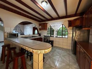 a large kitchen with a table and some chairs at Iguana Villas in Puerto Viejo