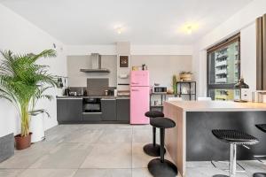 a kitchen with a pink refrigerator and a counter at Lumina I 3BR Apartment with Balcony I Parking I 2 Bathrooms I near Center in Warsaw