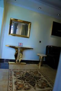 a room with a table and a mirror and a rug at KiGALI COMFORT AND CLASSIC STAY APARTMENT in Kigali