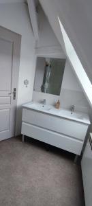 a white bathroom with a sink and a mirror at DUPLEX DE LA MOTTE in Beaumont-sur-Sarthe +12 photos