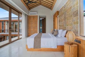 a bedroom with a bed and a balcony at Casa de Rua Villas in Badung +62 photos