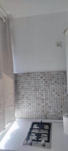 a kitchen with a stove top oven in a room at Apartament Bianco in Brăila +3 photos