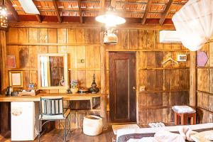 a room with wooden walls and a desk and a mirror at Mlis Kampot River in Kampot +39 photos