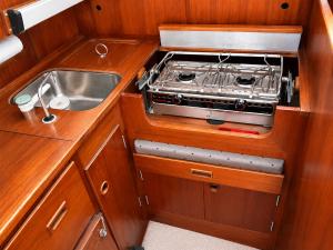 a kitchen with a sink and a stove at Varuna jachta in Nida