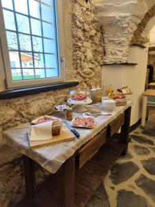 a table in a kitchen with food on it at Corte CeLestiale in Albenga