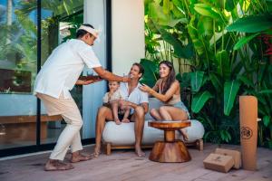 a man playing a game with a family at Candidasa Hills in Candidasa