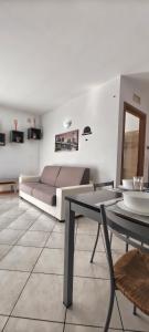 a living room with a couch and a table at Casa Vela in Riva del Garda