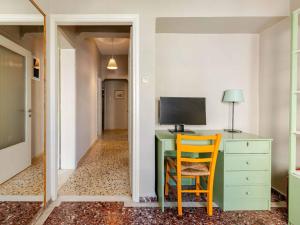 a desk with a computer and a chair in a room at 4BR Newly Renovated Retreat Tranquil Coastal Haven in Hersonissos