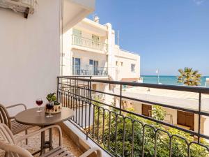 a balcony with a table and a view of the ocean at 4BR Newly Renovated Retreat Tranquil Coastal Haven in Hersonissos