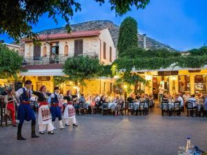 a group of people dancing in front of a crowd at 4BR Newly Renovated Retreat Tranquil Coastal Haven in Hersonissos