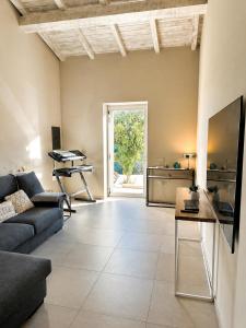 a living room with a couch and a table at MP Luxury House in Budoni