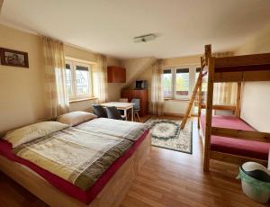 a bedroom with a bed and a table and chairs at Pod Jednym Dachem in Skawa +44 photos