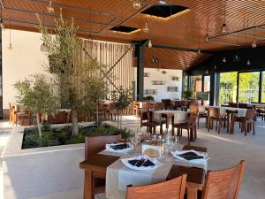 a restaurant with wooden tables and chairs and tables and tablesktop at Hotel Plamena Palace in Primorsko