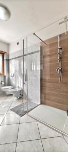 a large bathroom with a shower and a toilet at Casa Vela in Riva del Garda +10 photos