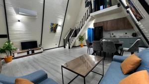a living room with a blue couch and a table at Aframezing Gabala in Gabala