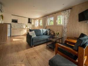 a living room with a couch and a table at Domki Zacisze, Okoniny in Śliwice