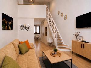 a living room with a couch and a staircase at Villa Diamond in Mostar