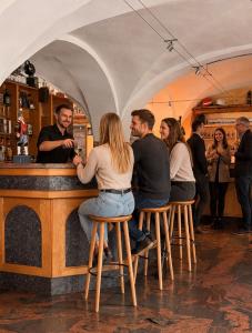 a group of people sitting at a bar at Hotel Maucksches Gut in Freiberg +11 photos