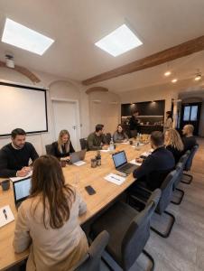 a group of people sitting around a table in a room at Hotel Maucksches Gut in Freiberg