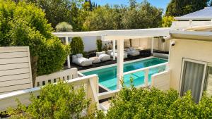 an aerial view of a house with a swimming pool at Liberty spa & suites - שלוש סוויטות ושתי ווילות מהממות עם בריכה פרטית in Manot