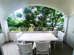 a white table and chairs on a balcony at Apartments Tomi in Novalja