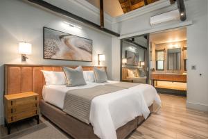 a bedroom with a large bed and a bathroom at Mokuti Etosha in Namutoni +51 photos