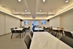 a dining room with tables and chairs at Ehan Hotel in Mokpo +79 photos
