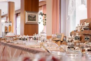 a long table with glasses and other items on it at GARNI' Margherita in Predazzo