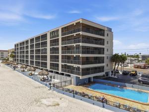 an office building with a pool in front of it at Villa Madeira 505 - Premier in St. Pete Beach