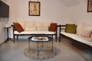 a living room with two couches and a coffee table at Avli in Samothraki