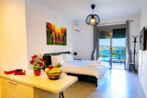 a bedroom with a bed and a table with fruit on it at Varkiza Riviera Studio by the Sea in Varkiza