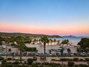 a view of a parking lot with palm trees and the ocean at Varkiza Riviera Studio by the Sea in Varkiza