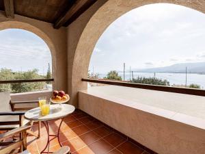 a balcony with two arches and a table with a bowl of fruit at Stalis Bay Villa in Stalís