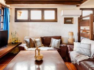 a living room with a couch and a table at Stalis Bay Villa in Stalís