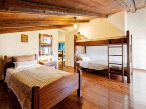a bedroom with two bunk beds and wooden floors at Stalis Bay Villa in Stalís +47 photos