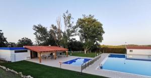 a large swimming pool with a gazebo next to at EL LLIMONER in Sant Jordi