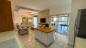 a living room with a table and a couch at Liberty spa & suites - שלוש סוויטות ושתי ווילות מהממות עם בריכה פרטית in Manot