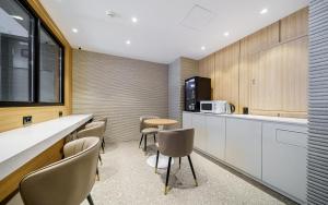 a kitchen with chairs and a table and a counter at d hotel in Seoul