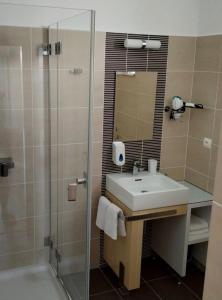 a bathroom with a sink and a shower at Štrbské Pleso rezidencia Oliver - apartmán 16A in Štrbské Pleso +25 photos