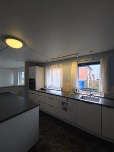 an empty kitchen with a sink and a window at Glentevej 4 in Ringkøbing